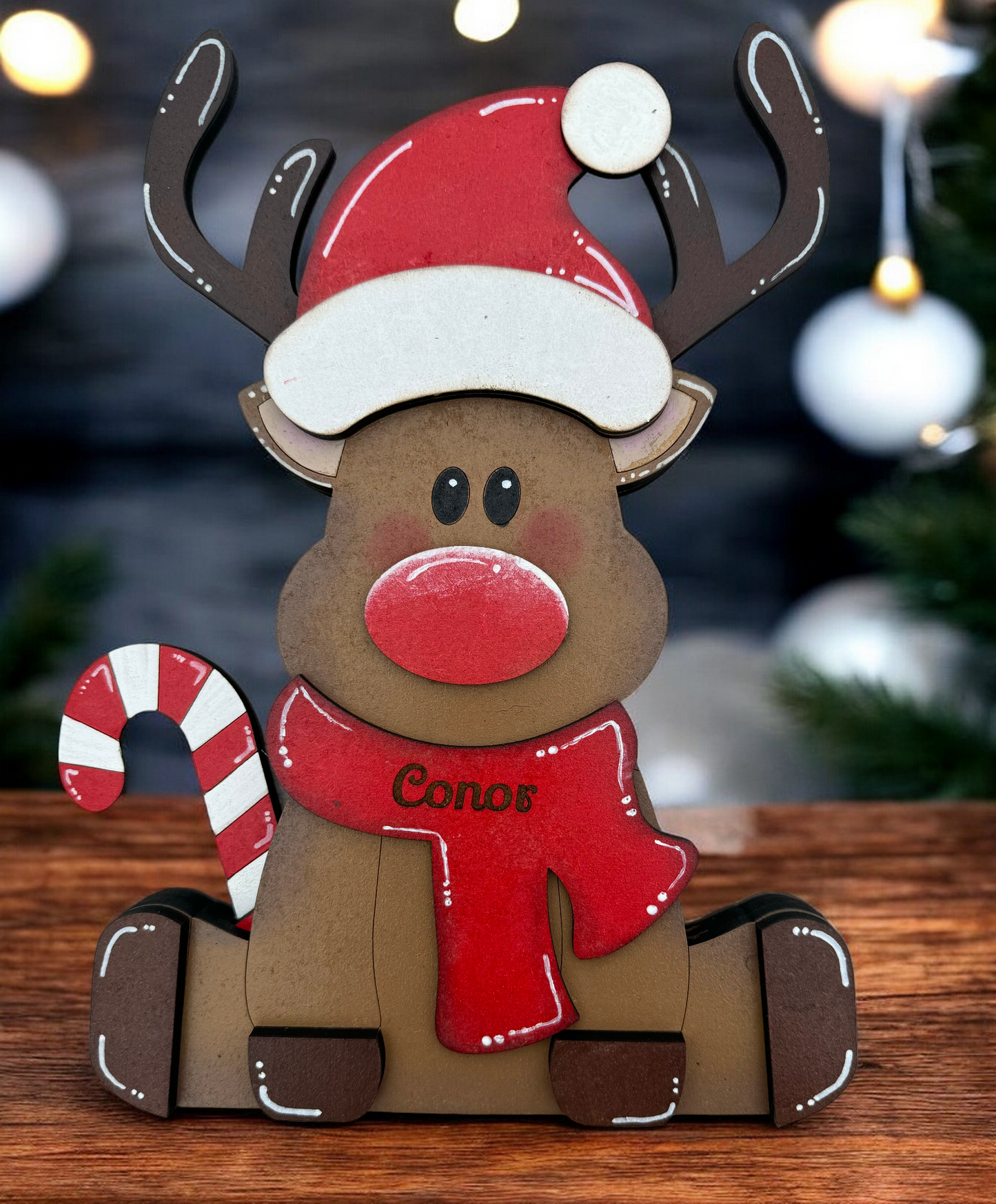 cute reindeer with personalised red scarf with candy stick and santa hat